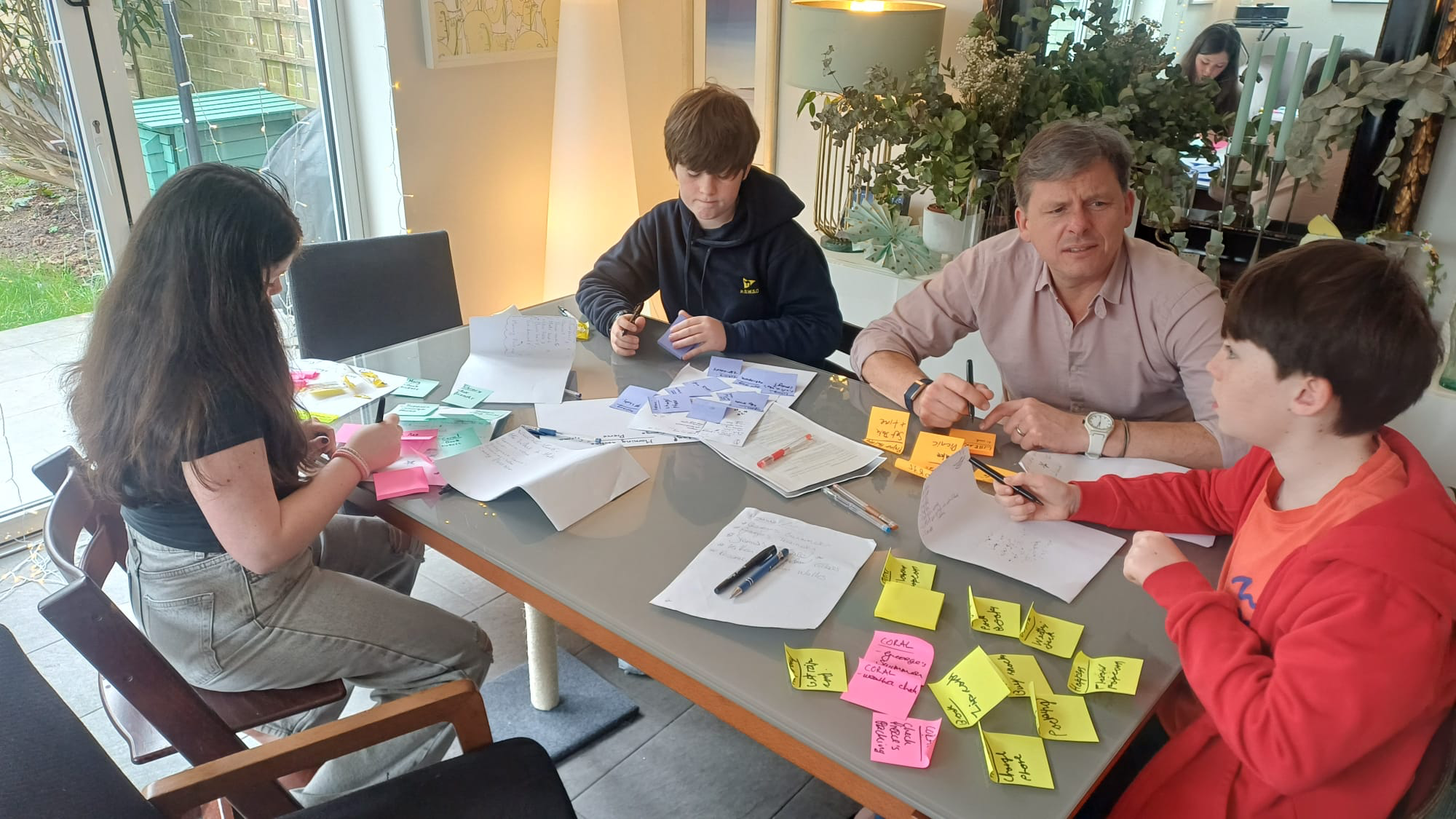 The Cadbury family planning their Easter staycation around a table with notes.